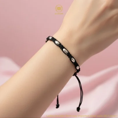 At Kanhaji Jewels (KJJ), we believe your baby deserves the purest protection. This unique Nazariya set features vibrant blue evil eye charms paired with delicate 2.5mm imported silver balls, creating a beautiful contrast against the traditional black beads. Crafted from certified 92.5 Sterling Silver, these bracelets are more than just jewelry—they are a symbol of love and safety. The blue evil eye is globally recognized for its power to ward off bad luck and negativity, while the silver beads add a premium, lasting shine that is gentle on your little one's skin. Key Highlights: Certified 92.5 Sterling Purity: Every silver bead is made of guaranteed high-purity silver, ensuring a hypoallergenic and durable finish. 2.5mm Imported Silver Balls: Features precision-crafted silver beads that offer a subtle yet sophisticated sparkle. Enhanced Evil Eye Protection: Adorned with multiple blue evil eye charms to provide maximum spiritual shielding for your baby. Soft & Adjustable Fit: Hand-strung on a comfortable black thread with a traditional red and black tassel finish for an easy, adjustable fit. The Perfect Blessing: An ideal gift for birth celebrations, naming ceremonies, or as a protective daily accessory for infants and toddlers. Product Specifications: Brand: Kanhaji Jewels (KJJ) Material: 92.5 Sterling Silver & Premium Protective Charms Silver Ball Size: 2.5mm (Imported) Design: Blue Evil Eye & Silver Bead Fusion Quantity: 1 Pair (Set of 2)