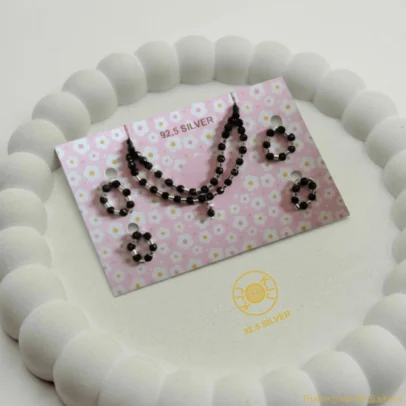 Regal Tradition for Your Divine Bal Gopal. Elevate your deity's daily appearance with the KJJ Elite Thakur ji Shringar Set. This comprehensive jewelry collection is designed to provide a majestic and coordinated look for your Laddu Gopal ji idol. The centerpiece of this set is a sophisticated double-layered necklace, featuring a harmonious blend of 92.5 Sterling Silver tubes and polished black beads that symbolize both purity and protection. Crafted from certified 92.5 Sterling Silver, every component in this set—including the matching bangles and rings—is meticulously handcrafted to meet the highest standards of spiritual jewelry. This set is an essential addition to your pooja shringar, offering a timeless aesthetic that honors ancestral traditions with a premium, modern finish. Key Highlights: Premium Double-Layer Necklace: Features a unique two-tier design with shiny silver tubes and black beads for a rich, layered aesthetic. Complete Coordinated Set: Includes one double-layer necklace, two matching bangles, and two delicate rings for a full deity makeover. Certified 92.5 Sterling Silver: Every silver element is guaranteed high-purity silver, ensuring spiritual sanctity and a brilliant, long-lasting shine. Sacred Protection: Combines the traditional "Nazar Battu" black beads with pure silver to shield your deity from negative energy. Perfectly Proportioned: Specifically sized to fit small to medium-sized Laddu Gopal and Thakur ji idols with ease and comfort. Product Specifications: Brand: Kanhaji Jewels (KJJ) Material: 92.5 Sterling Silver & Premium Black Beads Set Includes: 1 Double-Layer Necklace, 2 Bangles, 2 Rings Category: Deity Shringar / Temple Jewelry Quantity: 1 Complete Set